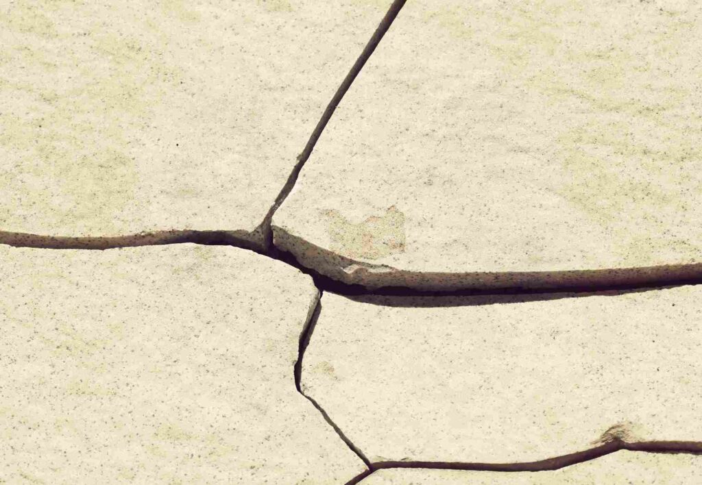 Cracked tiles bathroom — early sign of water damage behind tiles